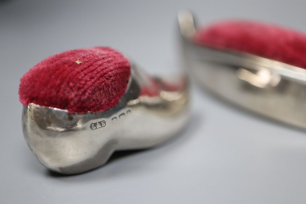 Two early 20th century novelty silver mounted pin cushions, canoe & clog, marks rubbed, canoe 9.5cm.